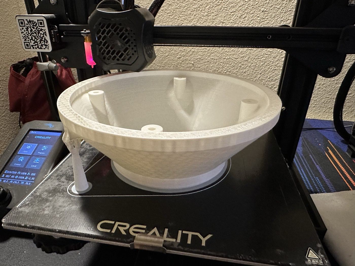 The conical base printing in white filament on a Creality bed