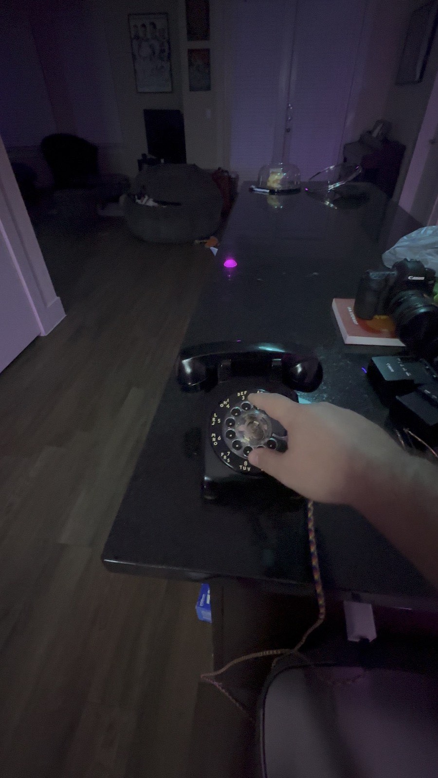 Dialing the phone in a room lit cold purple